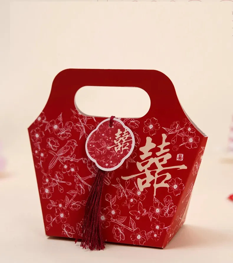 Red Floral Chinese Wedding Favor Boxes with Double Happiness Tassel on a light beige background