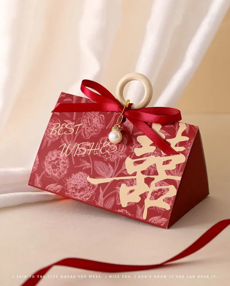 Red Floral Triangular Shape Double Happiness Favor Boxes gift box with floral design and 'Best Wishes' text, tied with a red ribbon for chinese wedding