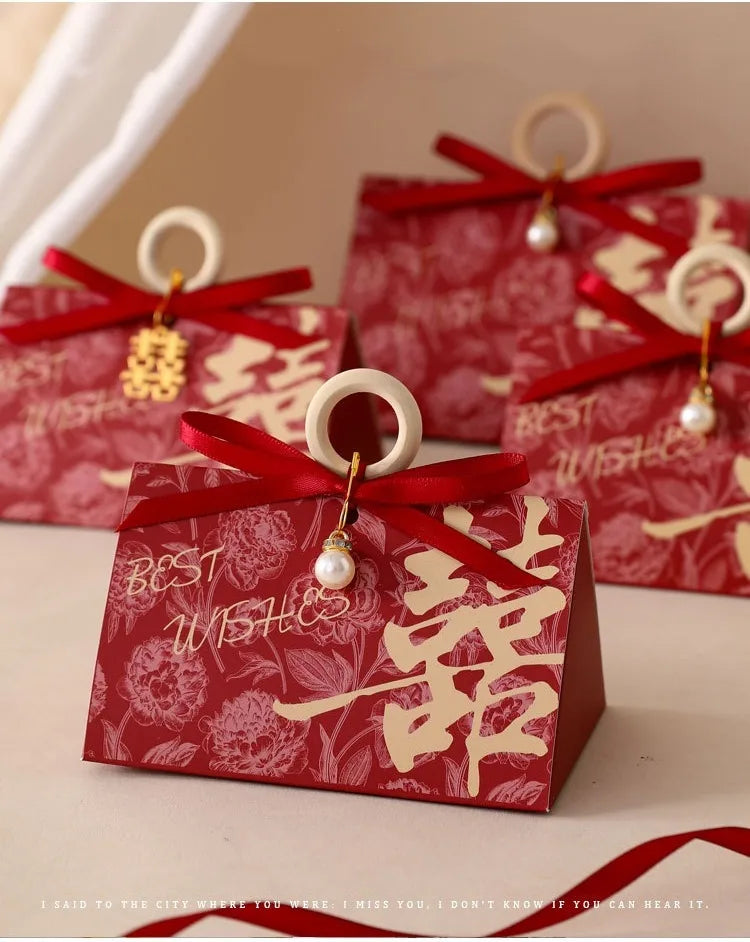 Red Floral Triangular Shape Double Happiness Favor Boxes gift box with gold text and decorative elements on a beige background