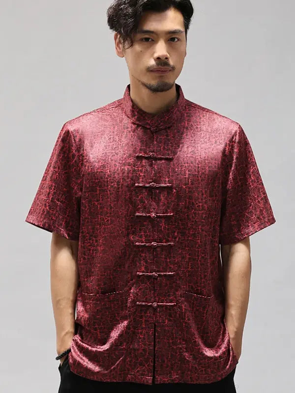 Man wearing a red patterned traditional Men's Luxury Mulberry Silk Jacquard Short Sleeve Tang Shirt against a gray background
