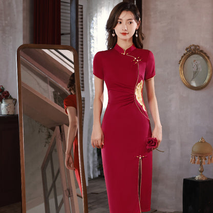  girl in red modern qipao dress. Featuring a peony flower embroidery on the waist , traditional mandarin collar, front side side slit