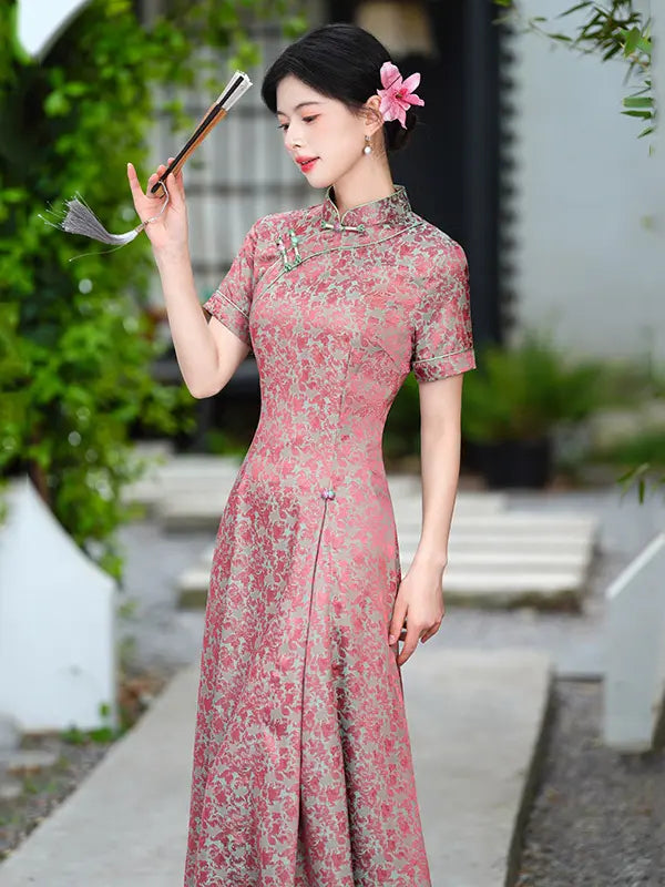 Woman in a pinkModern Floral Short Sleeve A-Line Qipao Dress  holding a fan outdoors.