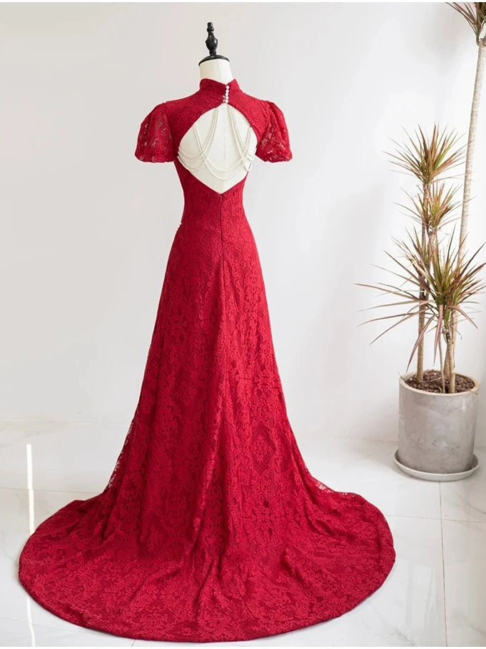 A red Open Back Lace Cheongsam/Qipao Dress With Train  formal gown displayed on a mannequin in a bright indoor setting. The dress features a high mock neck, short puff sleeves, a sweetheart back cutout with a white insert, and a full skirt with a long train.