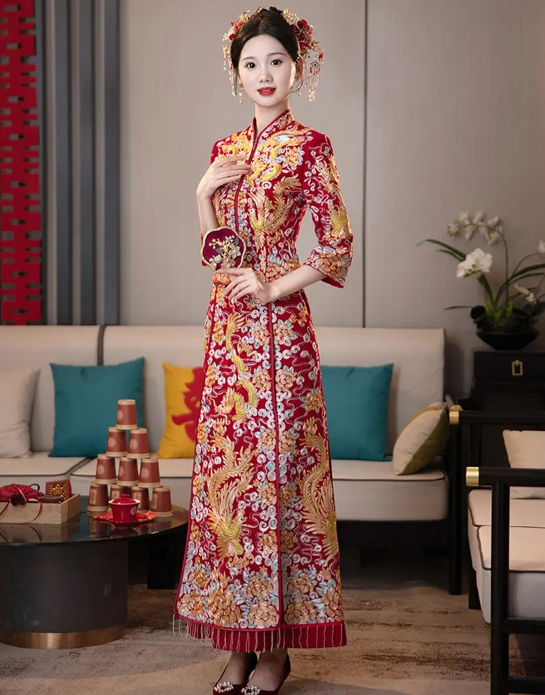 Heavily embroidered Qun Kwa featuring phoenixes and dragons symbolizing marital harmony.