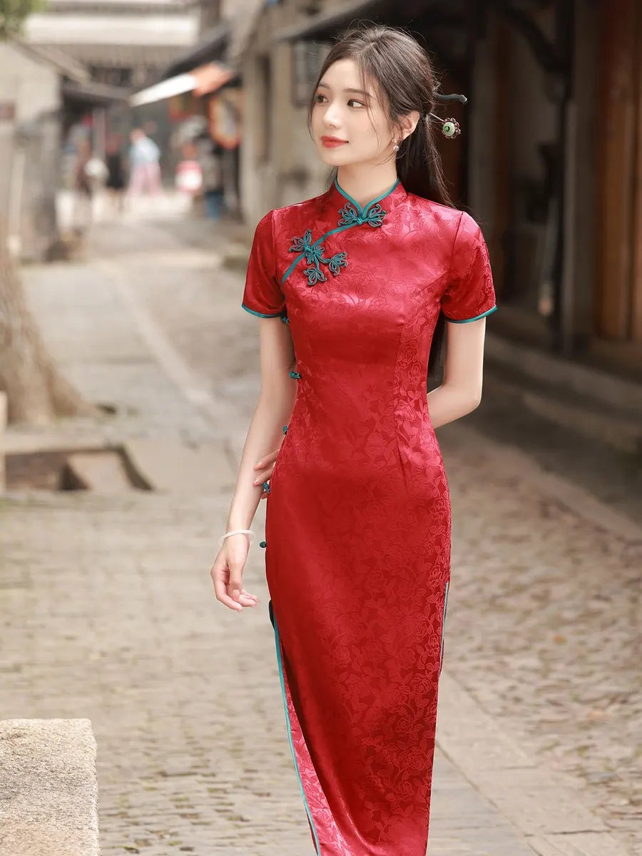 Woman in a red traditional Short Sleeves Floral Jacquard Long Qipao Dress With Blue Trim standing on a street
