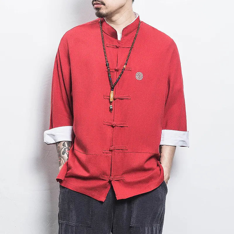 Person wearing a red traditional Three-Quarter Sleeve Zen Heritage Linen-Blend Kong Fu Tang Shirt with a plain background