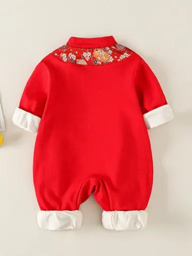 A baby's red one-piece Traditional Chinese Embroidered Baby Girl Qipao Romper  jumpsuit shown from the back, featuring a decorative floral collar and contrasting white cuffs and leg openings.