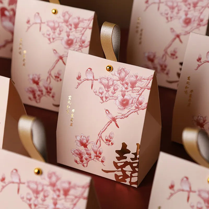 red and gold Double Happiness Wedding Favor Box  with Blossom & Bird design  on a wooden surface