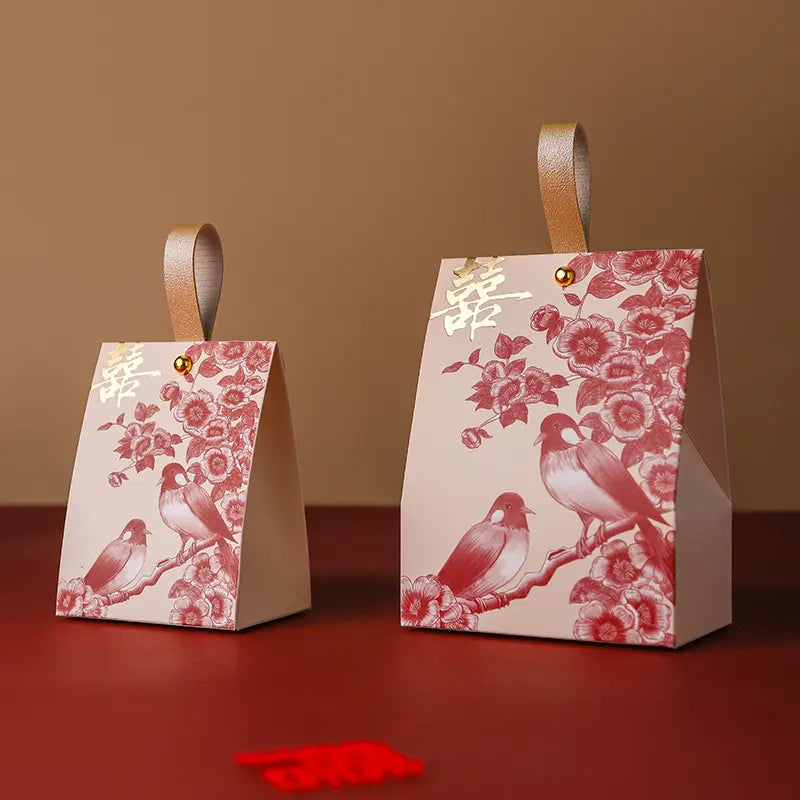 Two red and gold Double Happiness Wedding Favor Box  with Blossom & Bird designs on a brown background