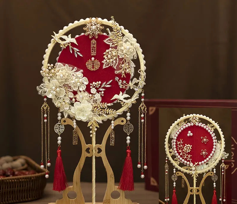 red and gold Chinese Bridal Round Hand Fan with Tassels  on a dark background