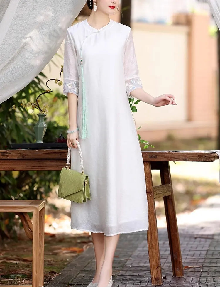 Woman in a white Loose A line Cheongsam Qipao Dress holding a green handbag outdoors