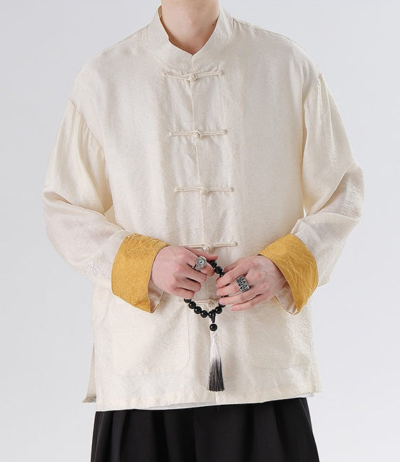 Person wearing a traditional beige Men's Oriental Jacquard Kung Fu Tang Shirt with yellow cuffs on a white background