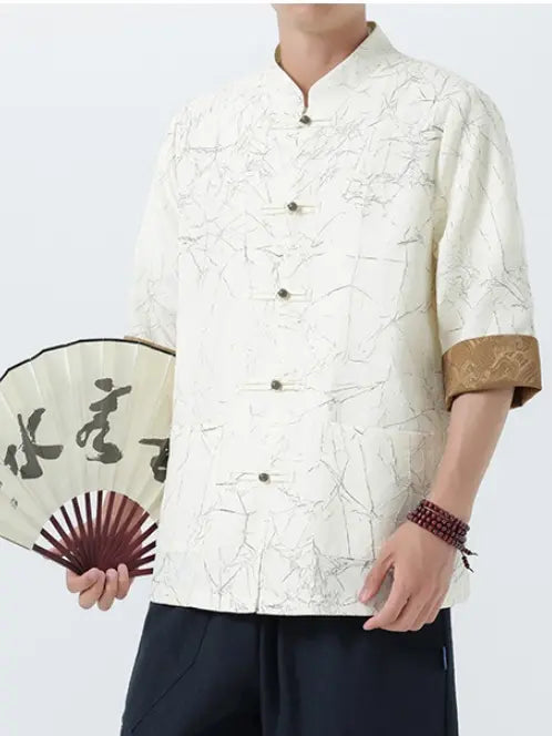 Person wearing a traditional-style Men's Retro Crinkle Texture Half Sleeve White Tang Suit Summer Shirtwith a fan, on a plain background