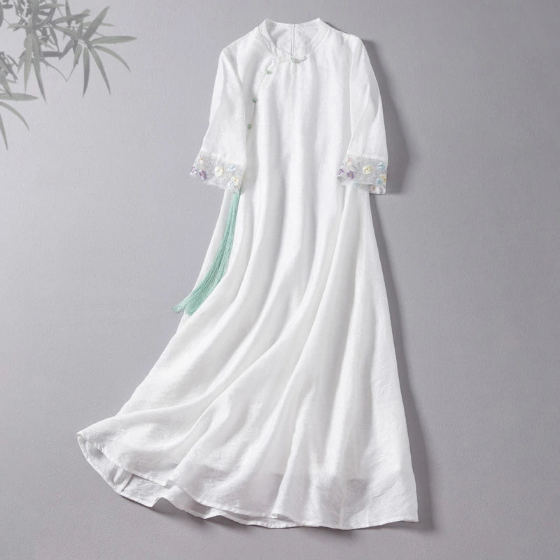 White dress with floral details on a gray background