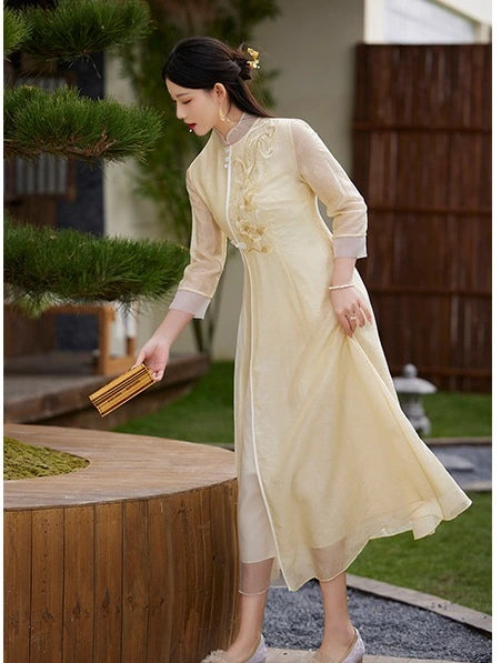 Woman in a Floral Embroidered Loose A line yellow Cheongsam Qipao Dress standing outdoors with greenery in the background